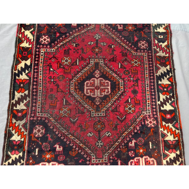 This antique hand-knotted rug showcases a bold Caucasian tribal design with a striking central medallion and geometric...