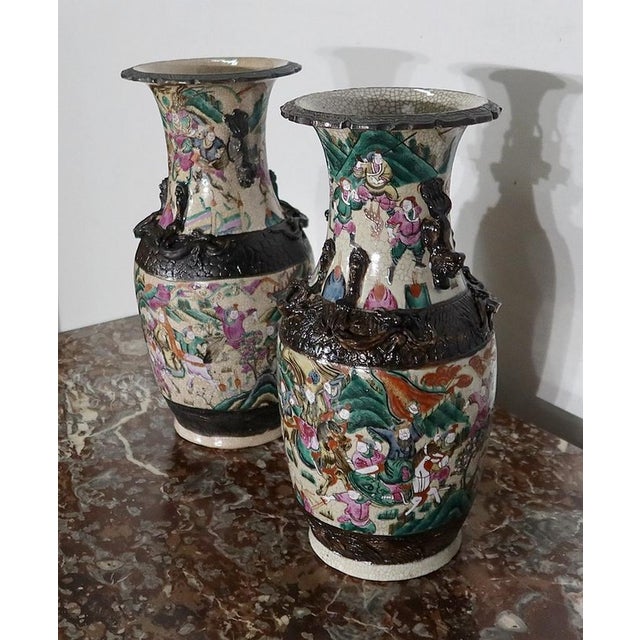 Pair of Chinese porcelain vases of Nankin, with beige cracked background with polychrome enamelled decor. Each vase has a...