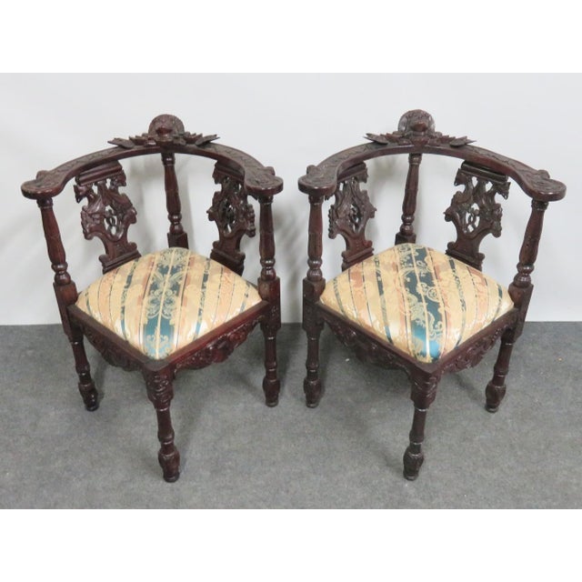 Victorian style corner chairs, mahogany frames, fully carved with woman's head on crest, dragons on back slat and various...