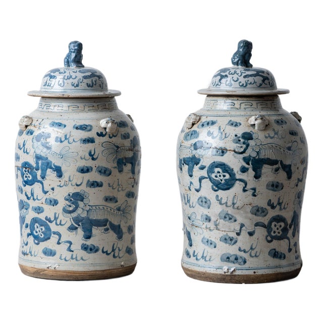 Pair of Chinese Blue and White Glazed Jars With Foo Dog Lid Finials For Sale