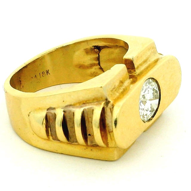 A bold and beautifully constructed vintage modernist ring crafted in 18K yellow gold, showcasing a bezel-set round...