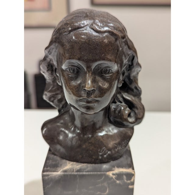 This bronze bust of a child at rest isn’t trying to be fancy or dramatic. This bronze has that beautiful, dark glow that...