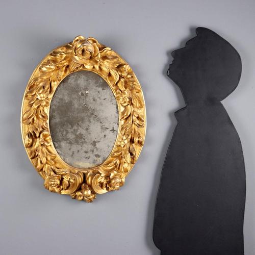 Baroque mirror in carved and gilded fir. Leafy and floral carvings, a central rose jutting out from the top, and scrolls...