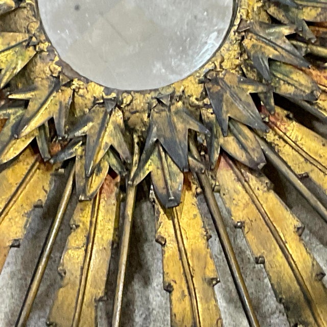 Vintage French Sunburst Gilt Metal Wall Mirror. Mirror features gold leaf paint on a metal frame with alternating lengths...