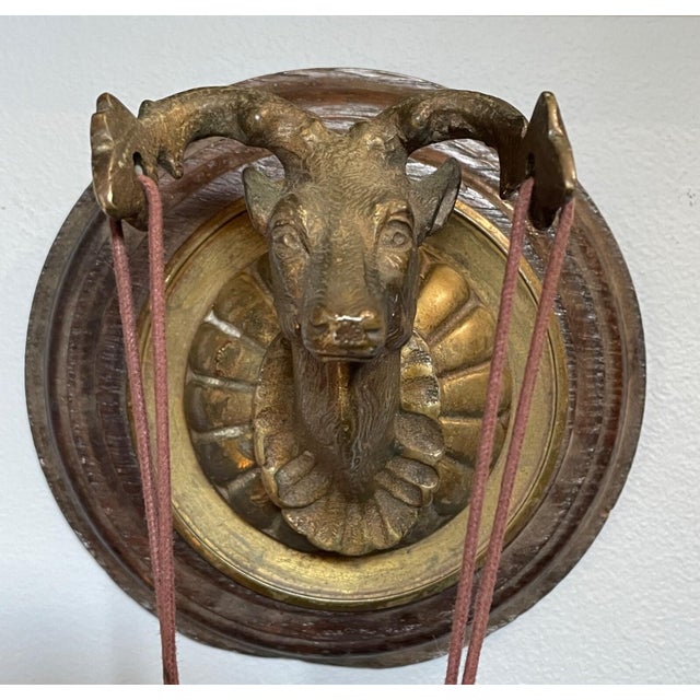 Antique heavy hand-hammered bronze and wood dinner gong. The gong is made of solid bronze, and hangs from a bronze deer...