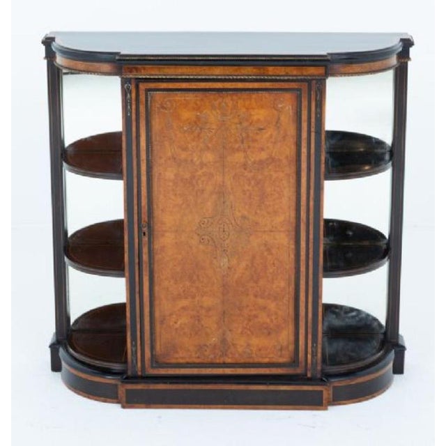 Victorian walnut and ebony side cabinet This cabinet stands upon a plinth base Circa 1860 The cabinet features bow ends...