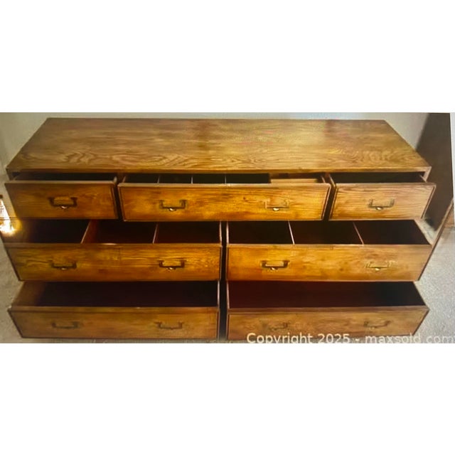 Beautiful vintage Henredon Artefacts 7-Drawer dresser in a classic campaign style, featuring warm oak tones, and recessed...