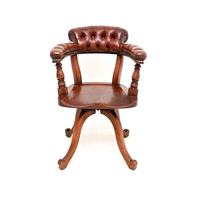 A superb antique Victorian oak and leather swivel desk chair by James Shoolbred. This was made in England, it dates from...