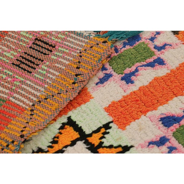 Hand-knotted in wool and originating from Morocco circa 1950-1960, this 2x8 vintage Moroccan rug is an extremely rare...