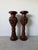 A striking pair of vintage handcrafted Asian floor vases, expertly carved from solid teak wood. These decorative vessels...