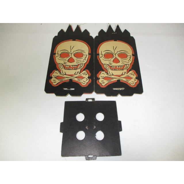 Vintage early 1950's cardboard Halloween black lantern with white skull and crossbones cutouts on the four sides lined...