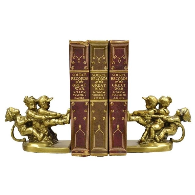 Vintage PM Craftsman "Tug of War" Brass Children Playing Figural Bookends - Pair. Circa Late 20th Century. Measurements:...