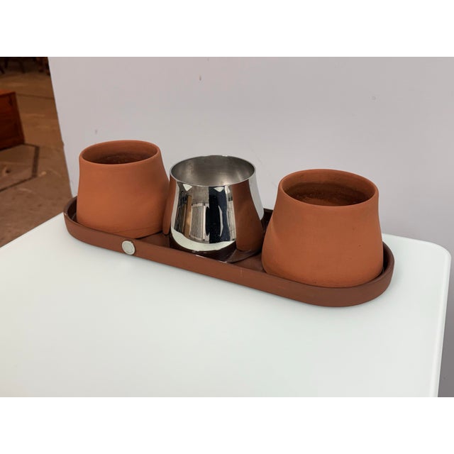 Design Plus Gallery presents the Terra Tray + Three Pots from Georg Jensen. This sculptural Terra set by Georg Jensen...