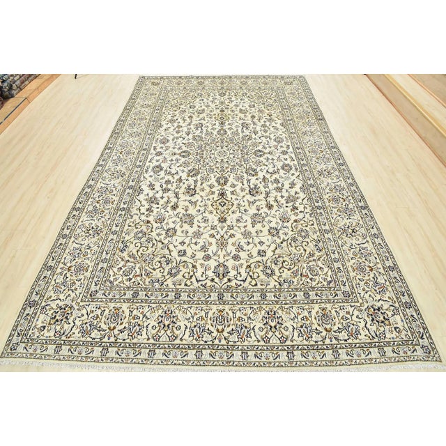 An authentic vintage traditional Kashan rug hand-knotted with fine wool and natural dyes. This oriental rug features a...