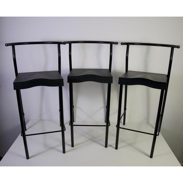 Set of three black bar stools by Philippe Starck for Kartell, Italy, 1980s. This striking vintage set features slender...