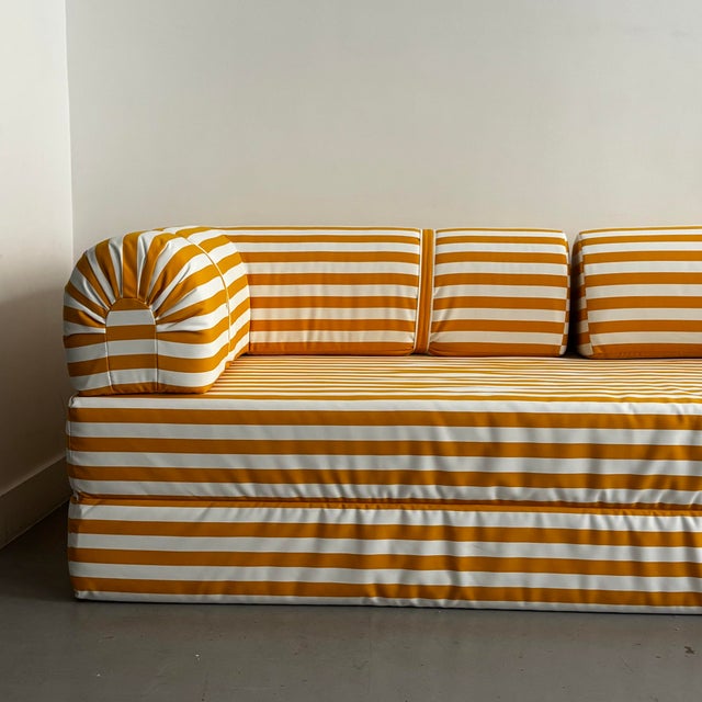 Sofa bed fully reupholstered in white and yellow striped fabric. In perfect condition. Fully removable covers. This piece...