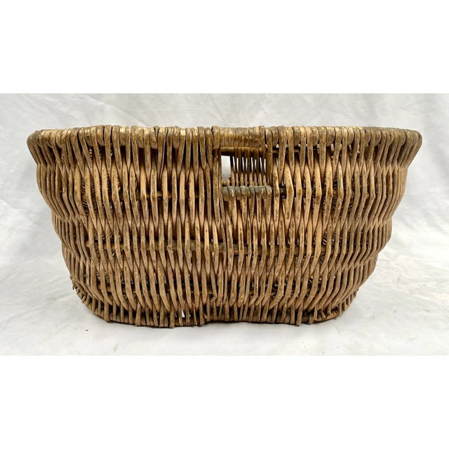 Imported from France. Large handcrafted woven wicker gathering basket. Circa late 1800s. Woven over a wood dowel for...