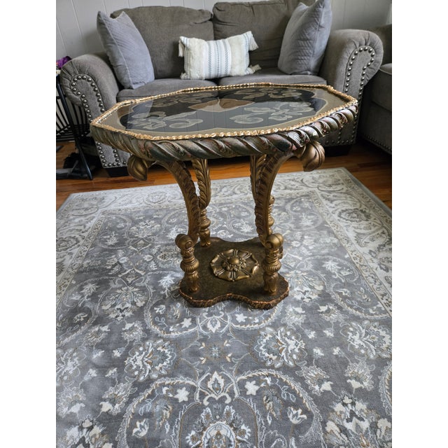 Vintage Hollywood Regency hand-painted, brass gilded occasional/accent table featuring a recessed eglomise glass top with...