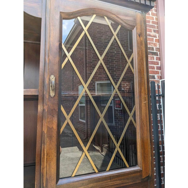 A stunning antique china cabinet featuring beautiful woodwork, glass-paneled doors, and classic detailing. Well cared for...