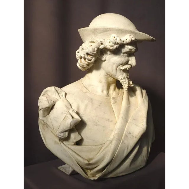 Important marble sculpture of a man's bust draped in antique style signed Augusto Benvenuti and dated 1874,Venezia. This...
