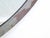This round, solid bronze frame mirror has an old patinated finish.