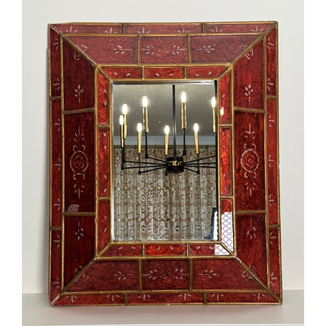 A vintage frame with a five inch deep depth and raised appearance encompassing rich red, oxblood, and gold colors encircle...