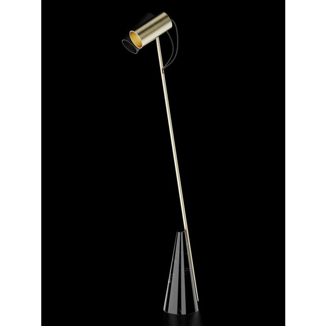 Floor lamp with Marquinha black stone base, brushed brass structure and double lightshield made in black paint and brushed...