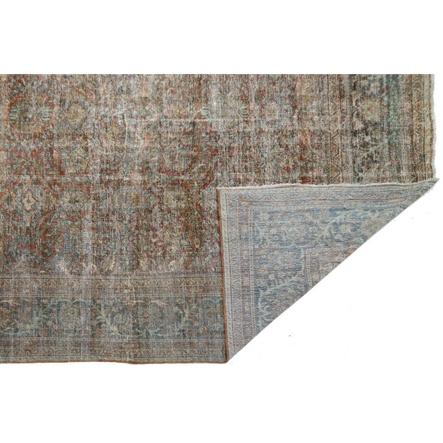 An extraordinary early 20th-century Antique Mahal wool rug, featuring a beautifully distressed, soft aesthetic that exudes...
