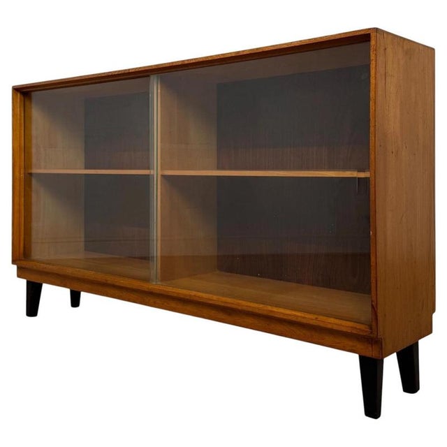 A superb vintage 20th-century teak display cabinet by Gordon Russell, exceptionally well crafted and distinguished by its...