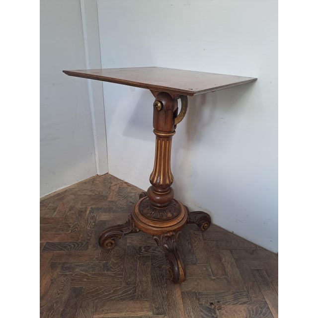 A fine Victorian walnut tilting reading stand, with a richly carved and polychrome-decorated column and elegant carved...