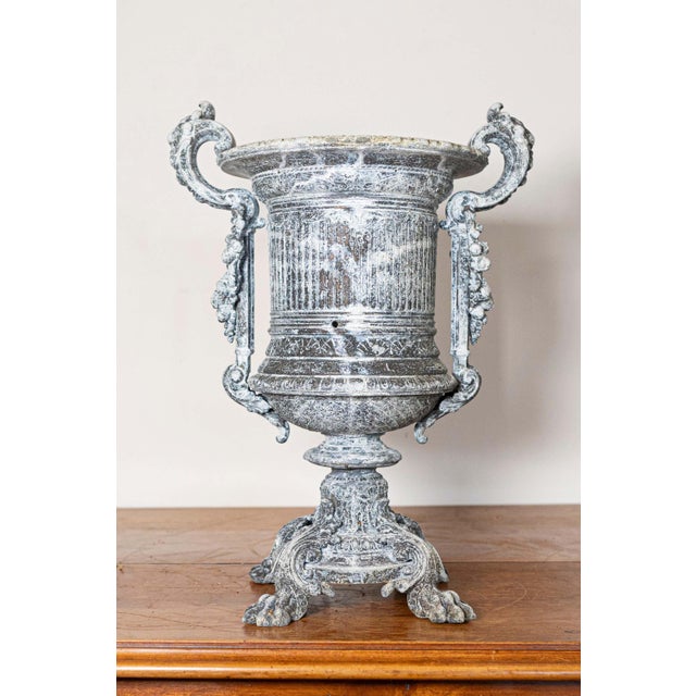 This imposing 19th-century French urn is a masterful example of neoclassical design, embodying elegance and grandeur....