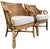A pair of Henry Link Saint Andrews scroll arm club chairs with woven rattan panels and a warm honey-toned finish. The...