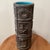 This Art Pottery Numbered Cylindrical Vase with a Hand Carved Geometric Design and blue glaze inside by R.M. is a unique...