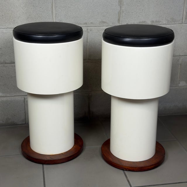 A pair of modernist bar stools attributed to Italian craftsmanship of the 1960s, characterized by an iconic Space Age...