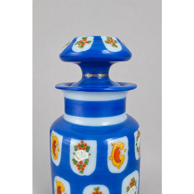 A striking late 19th-century Bohemian opaline glass perfume bottle, dating to approximately 1870–1890. The bottle features...