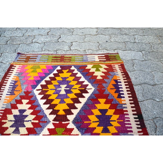 This is a vintage Turkish Anatolian kilim rug from the 1960s. The piece was hand-woven.