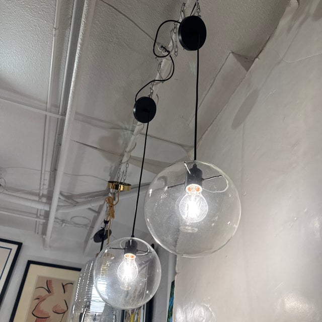 Design Plus Gallery presents a Pair of Contemporary Globe Pendants from Visual Comforts. Each pendant showcases a...