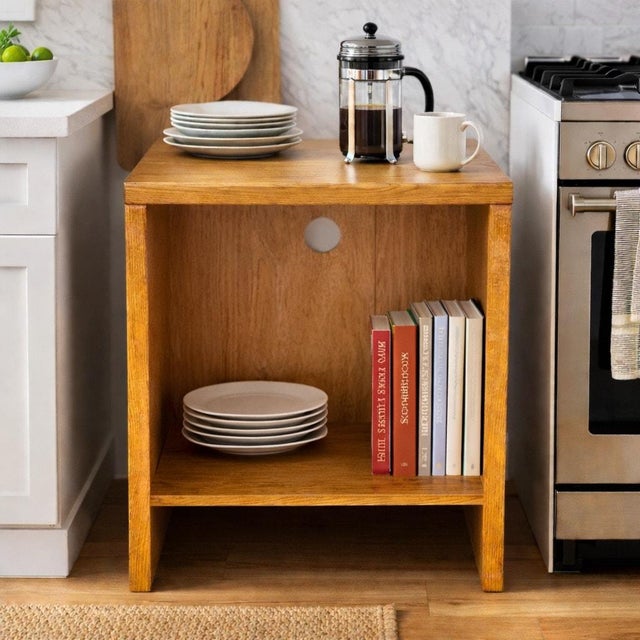 This late 20th-century American pedestal cabinet is defined by its architectural silhouette and honest materiality....