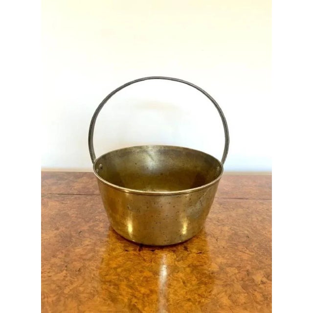 Antique Victorian quality heavy brass jam pale, having an iron shaped handle with a quality brass jam pale.