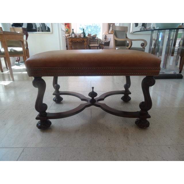 A fabulous Ebanista Style Leather bench in the Italian baroque style. Nicely Carved and with a double nailhead trim. This...