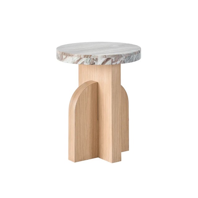 The Accent Table displays a stunning combination of a smooth marble top and an angled, oak-finished pedestal base,...