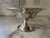 This elegant sterling silver compote would be a lovely addition to any space. The five pedal design opens up to an...