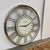 Design Plus Gallery presents a Wall Clock from Thomas Moore. The clock is mostly chrome with roman numerals going around...