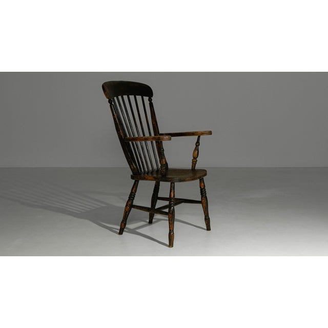 This 19th century English Windsor armchair exemplifies the enduring appeal of vernacular craftsmanship and honest...