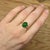 A vivid oval 3 carat Emerald looks exquisite in this elegant ring with cute earth mined diamond accents in solid 14k gold....