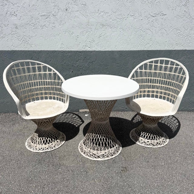 A striking blend of sculptural form and airy design, this mid-century modern spun fiberglass bistro set embodies the era’s...