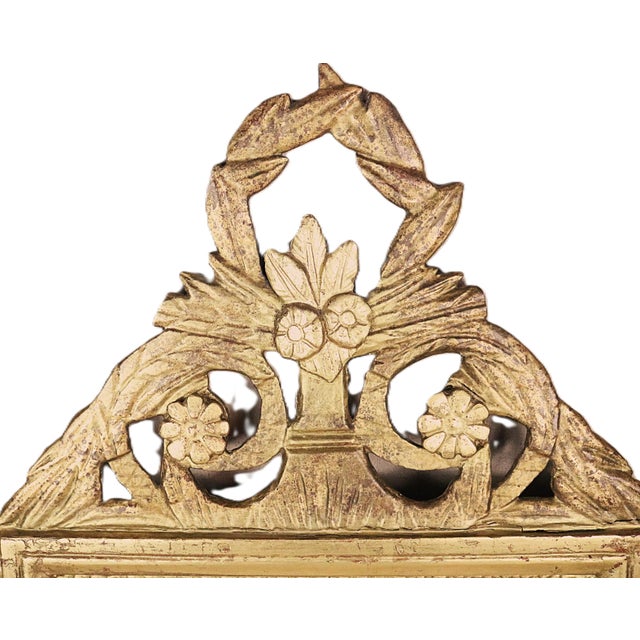 A French wall mirror in the style of Louis XVI and dating from the end of the 18th century. This type of mirror is...