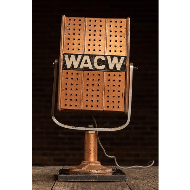 Early broadcast desk microphone featuring a perforated painted wood housing with bold applied “WACW” call-letter badge...
