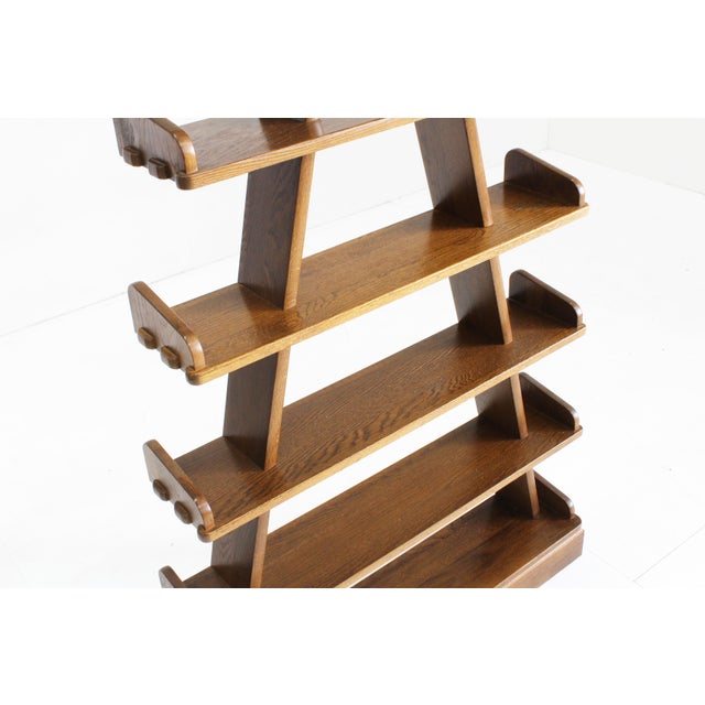 Brutalist pyramid shaped book case /shelving unit in wood. This triangular shelving unit is ideally used for displaying...