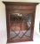 Antique cupboard with a unusual sliding door from side to side. Glass has been replaced with bubble glass. Aged mahogany...